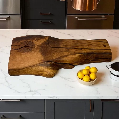 Irregular handcrafted solid wood cutting board with hanging hole, ideal for serving and cutting food in the kitchen.