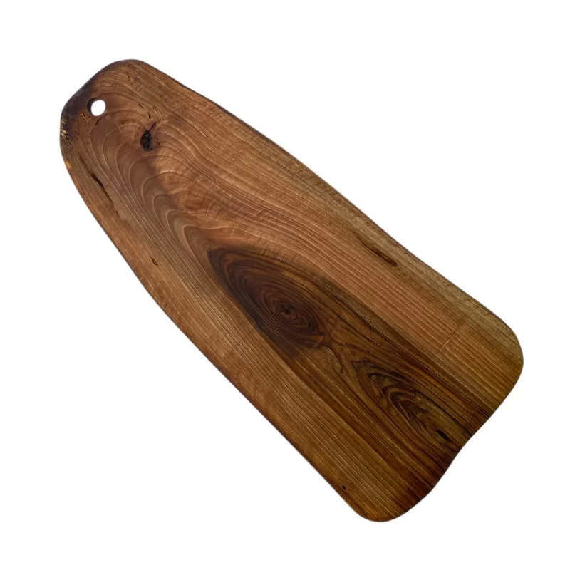 Irregular solid wood cutting board with hanging hole, ideal for serving and cutting food in the kitchen.
