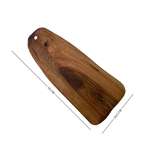 Irregular solid wood cutting board with hanging hole, ideal for serving and cutting food in the kitchen.