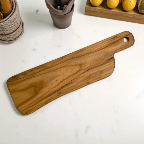 Handcrafted, narrow, rectangular cutting board made of solid, hand-sanded wood with a hanging hole, ideal for serving appetizers and cutting food.